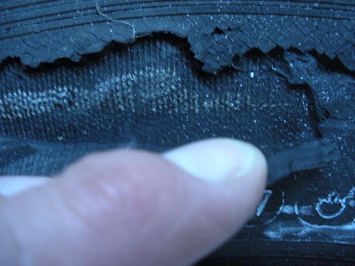 Close up view of the crack shown above; pulled back to show extent of the damage—all the way down to the belting. Very dangerous!