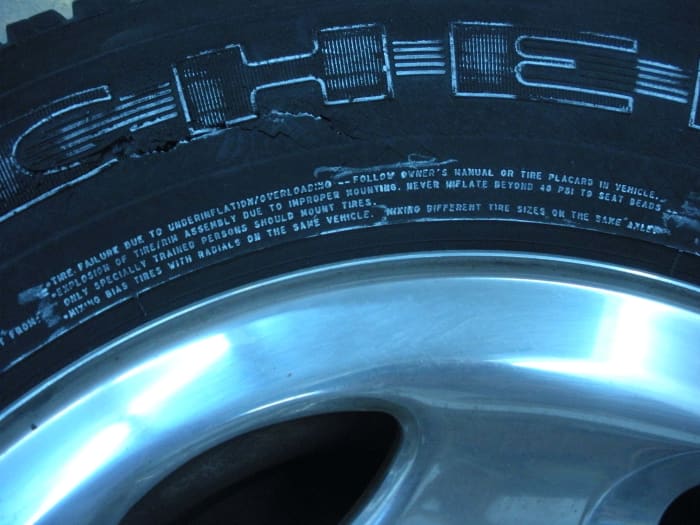 In small print on the tire, it warns against over-inflation, and lists the dangers. Even with an extreme close up, and highlighted in white chalk, it is hard to read.