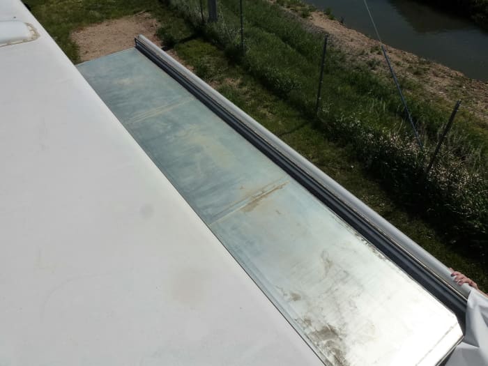 The top of the slide out is exposed. This will be the last time you ever see it, so take a moment and clean off any debris.