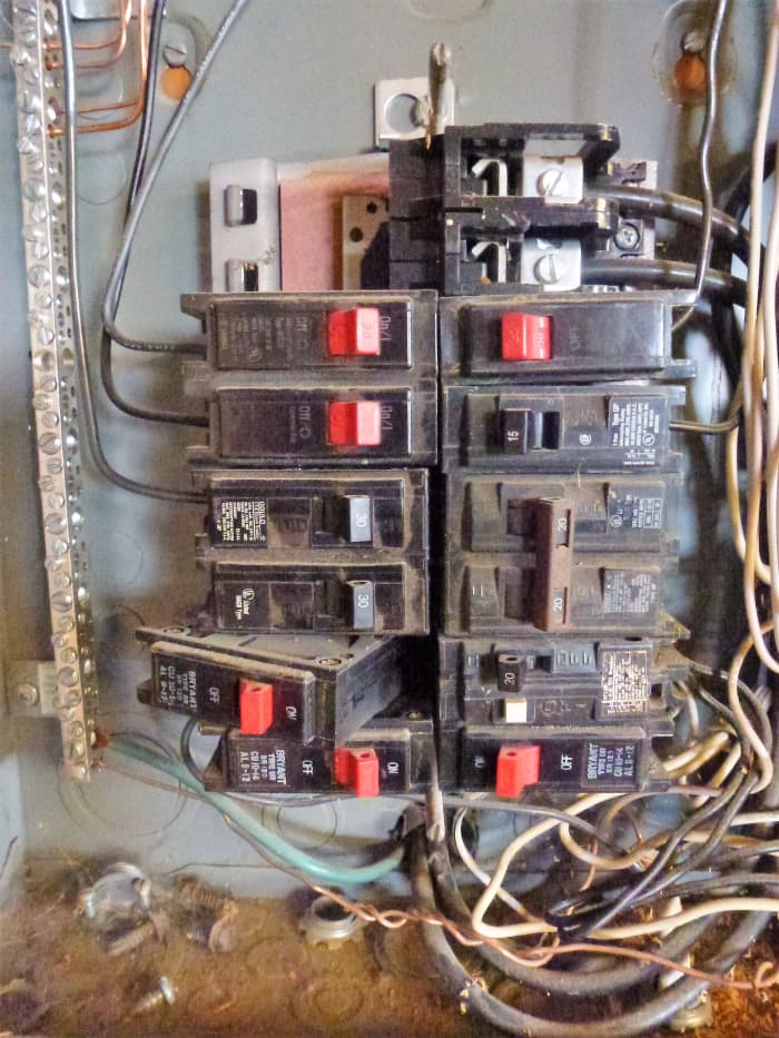Installing a breaker. The left side (nearest the edge of the panel) is hooked into the framework and it is being pushed down in the center. It may take some force.
