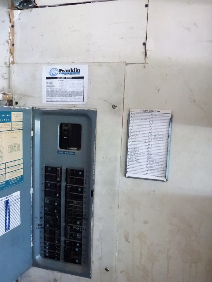 The sheetrock above this panel has been cut out in the past to put new wire in, and then replaced. The main breaker is the one at the top of the panel.