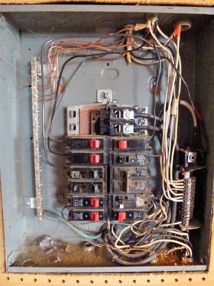 Inside a panel. This panel has no main breaker. The ground bus is on the left, with the neutral bus on the right.
