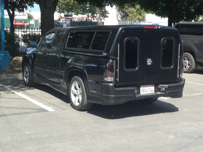 This shell is very unique. This is the SnugTop Outback. The tailgate is fully removed. The shell is still cab level. It offers a variety of other options, like back up camera and roof racks.