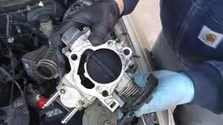Removed Toyota 5SFE throttle body with carbonized throttle plate