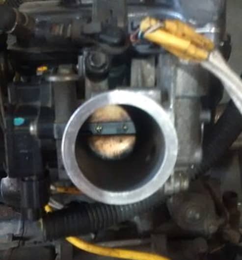 Check and remove buildup from the throttle body, if necessary.