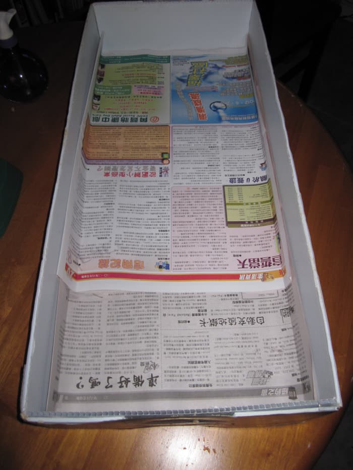 And here we have the old newspaper to help absorb urine. It helps to remove the wood chips when cleaning.