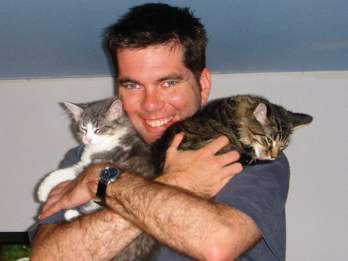 Men like cats, too. They just hide it better. Except this guy. He's terrific at showinjg his feelings. Don't you just want to hug him?