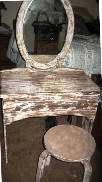 Recycled desk, with recycled bathroom vanity mirror. Add a stool and you have a new antique vanity set.
