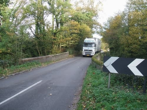 A big lorry on a small bridge in rural England