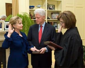 Secretary of State Hillary Clinton, with her husband, being sworn into office, in 2009.
