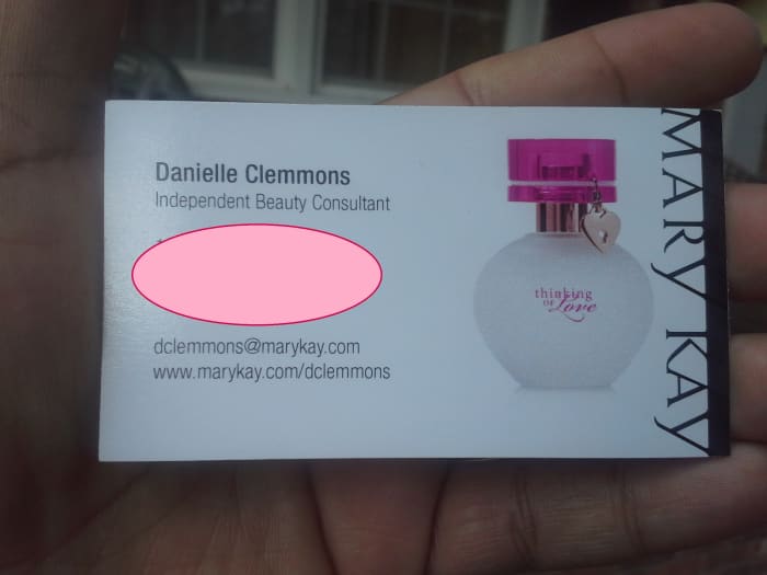 Professional business card on high-quality, semi-gloss paper. (The pink circle is covering up personal info, not a part of the card.)