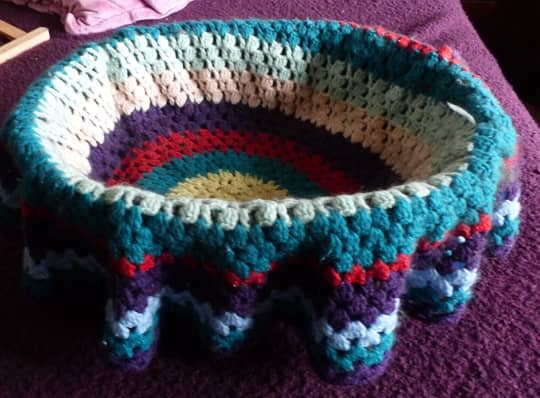 Never thought I would use these round afghans until the idea hit me...great cat basket blanket!