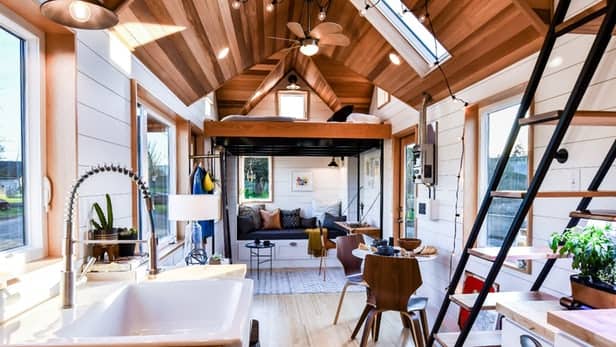 A crisp, clean interior is easy to achieve with a tiny house. Storage can be built in under the stairs or in cabinets on the walls, and because it's such a small space, clutter won't build up to unmanageable levels.