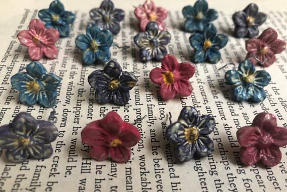 These little flowers pop on the background of an old book. The only problem may be a slight shadow, which is not really a problem in this case.