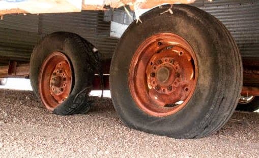 The black coloration in tires is actually an electric conductor, so just because you have rubber tires doesn't mean you are properly insulated or totally protected from overhead wires.