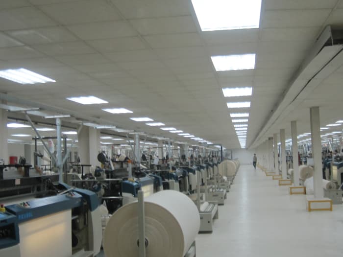 Fabric production floor (above). Fabric producers are suppliers for clothing manufacturers.