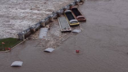 Cover tops made of steel or fiberglass are used to protect certain kinds of cargo, like that of grain barges.