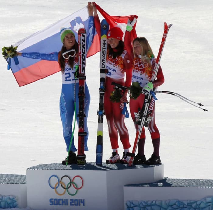Downhill skiiers Tina Maze from Slovenia and Dominique Gisin from Switzerland tied for the Gold Medal in the 2014 Winter Olympics. Here, they share the spotlight with Bonze medal winner Lara Gut from Switzerland.