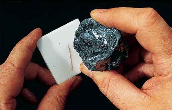 A mineral creating a streak on an unglazed ceramic tile