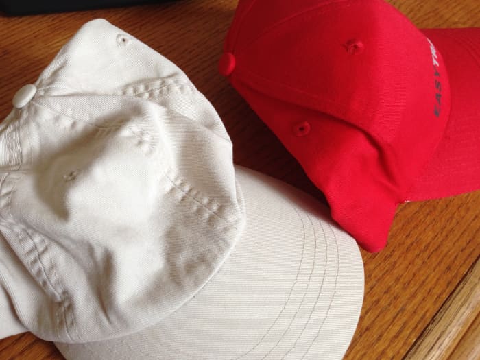 Promotional custom hats can be either soft and unstructured (left) or structured with stiffening materials (right).