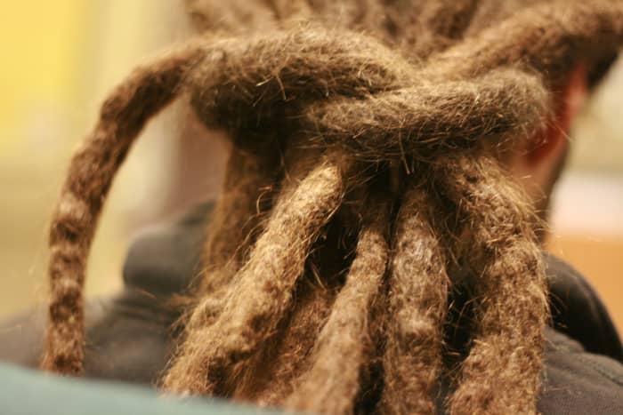 People wear dreadlocks for both religious and non-religious reasons. Members of the Rastafarian sect often wear dreadlocks and untrimmed beards. Employers may pressure them to comply with company dress codes.