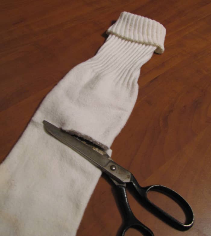 The top part of this sock gets repurposed into a doll dress. The bottom part becomes a cleaning rag.