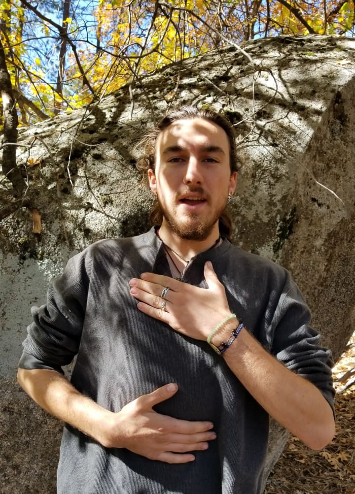 Singer/Actor, Wren shows one hand on the chest which is incorrect for breathing, and the other on the belly for correct breathing.