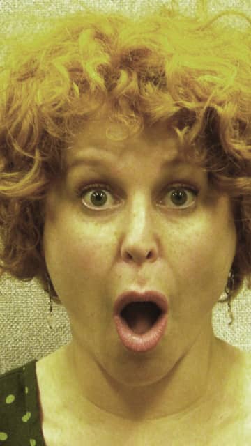 A Professional Singer warming up the vocal folds (chords.) Lifting the eyebrows helps to improve the sound.