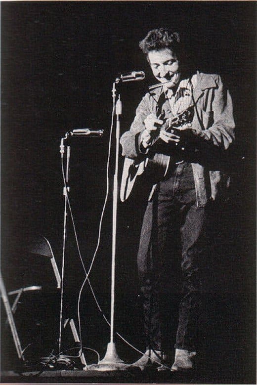 A young Bob Dylan performing at St. Lawrence University in New York. Dylan began his career playing solo on an acoustic guitar. It caused great controversy when he switched to an electric instrument and got a backing band in folk circles.