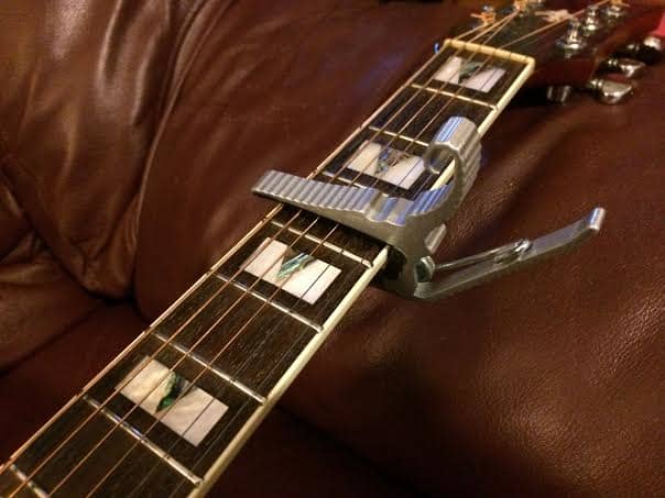 A capo is a great way to make those ridiculous barred open chords easier for small handed guitarists