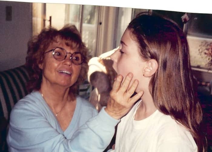 I'm gently helping this young lady learn how to drop her jaw for a bigger mouth opening. Doing so will project her tone and keep her singing on key.