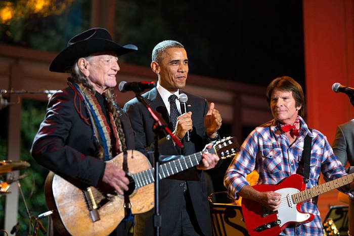 President Barack Obama joins Willie Nelson and John Fogerty onstage at the conclusion of "A Salute to the Troops: In Performance at the White House" on the South Lawn of the White House, Nov. 6, 2014. (Official White House Photo by Pete Souza)