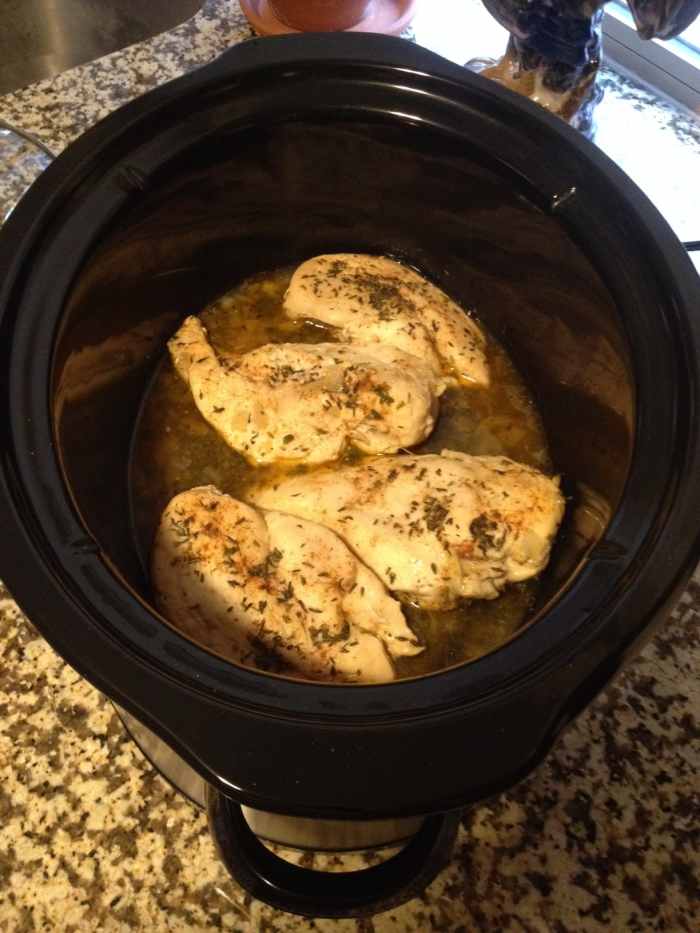 Seasoned chicken, in the crock pot, just before cooking and before the baby carrots have been added.
