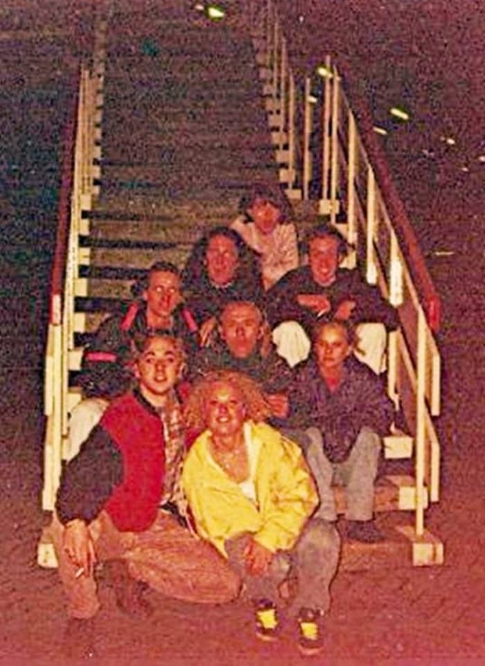 Sitting on the motorway services (1991). My friend Carol is right at the back. On the step in front of her are Zoe (on the left) and Glyn. Right at the front, in the yellow jacket, is Jane.