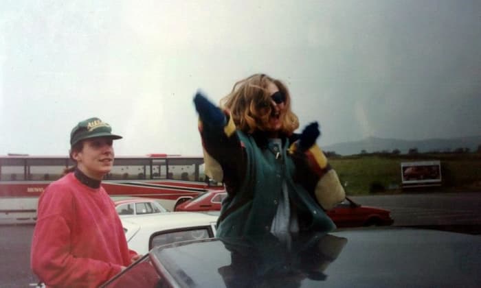 Mandie dancing through my car sunroof on the motorway services, watched by Franny (in the red jumper).