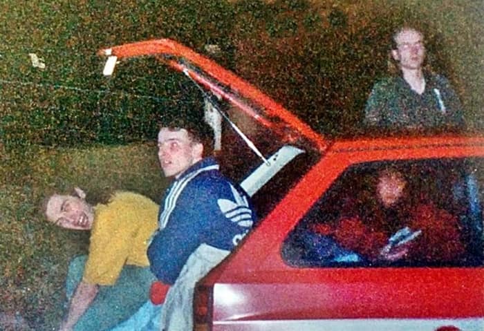 My friend Bollie (in the yellow t-shirt) getting changed in the back of a car outside Monroes (1991).