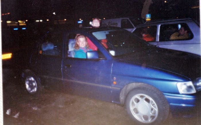 My friend Andrea from Blackpool sitting in the driving seat of the hired Rover, with Julia putting her head out of the sunroof, on the services, 1991. (No, she didn't travel on the motorway standing up like that!)