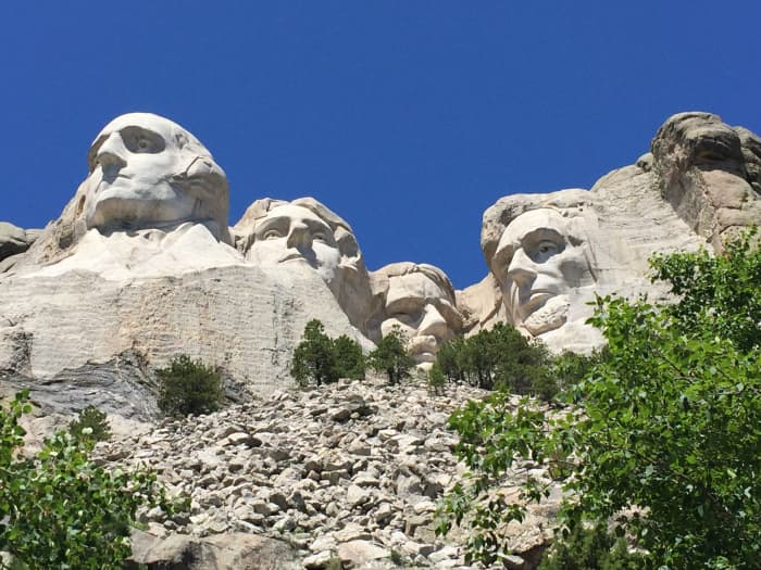 Mt. Rushmore is an American historic monument well worth seeing. It features the faces of George Washington, Thomas Jefferson, Theodore Roosevelt and Abraham Lincoln. The heads are nearly 60 feet high, carved into South Dakota's granite.