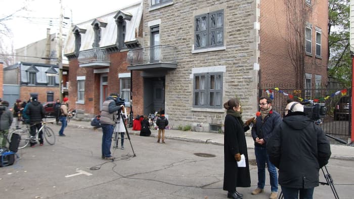 News crews gather in front of Leonard's Cohen's home in Montreal, following the announcement that the popular poet-singer had just passed away.