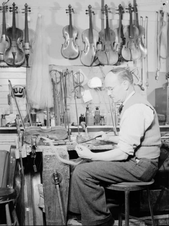 Mr Forget, luthier, sets a horsehair bow.We note violins, violas and various tools in the workshop of the craftsman of stringed instruments.