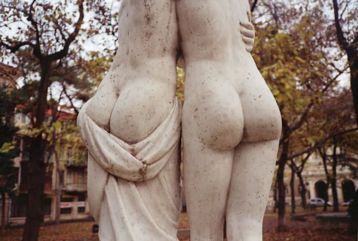 Why are statues always unclothed? Give these gals a cover up. They're obviously huddling from the cold.