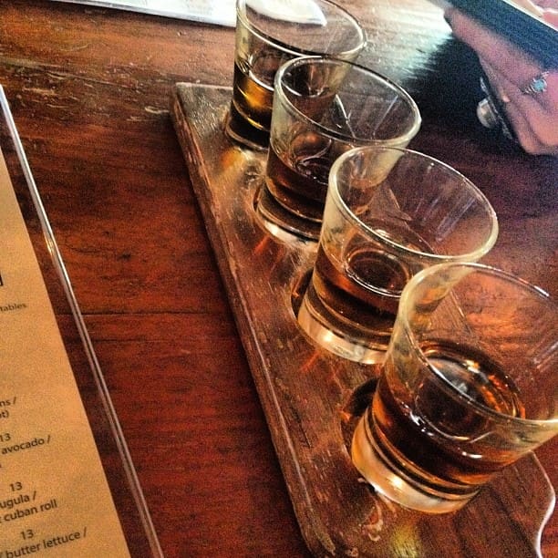 Whiskey (or "whisky" in Canada and Scotland), is a distilled alcoholic drink produced from fermented grain mash (typically rye, barley, corn, or wheat). It has a distinctive brown color and is aged in charred oak casks.