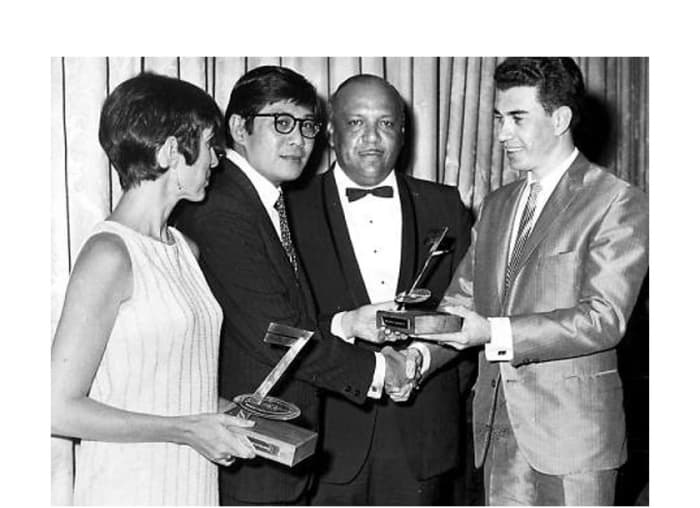 Hugh Gentles (right) presents a West India Records Limited (WIRL) Award for producer of best-selling 45 single to Leslie Kong (second left) in 1971