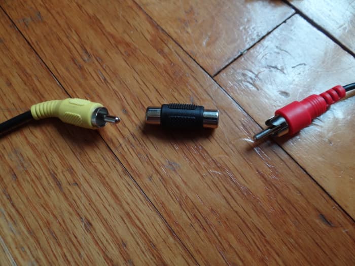 Coupler (shown in the midde) is used to link the speaker cable to the Stereo "Y" Adapter Cable.