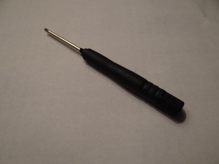 Using this mini screwdriver I connected the wires with black coloring to the left and right hole and the wires with red coloring together in the right hole.