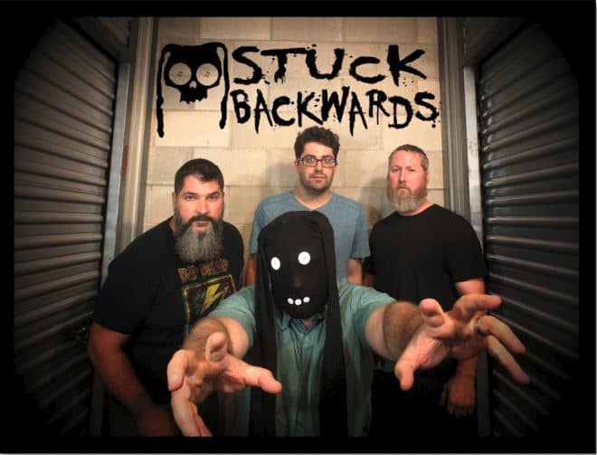 Stuck Backwards, Back row: Mike Puke (guitar), Johnnie Ashtray (drums), Nate Masturbate (bass) Front: He-Mutha Johnson (vocals)