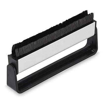 A record cleaning brush is a dry brush with bristles that will gently get into the grooves and clean any loose dust or debris.