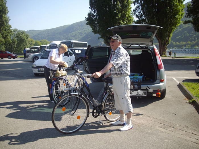 A couple on a cycling trek on banks of Rhine River (Germany).