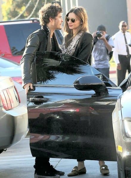 Orlando Bloom is the perfect gentleman as he opens the car door for his girlfriend, Victoria's Secret model Miranda Kerr.