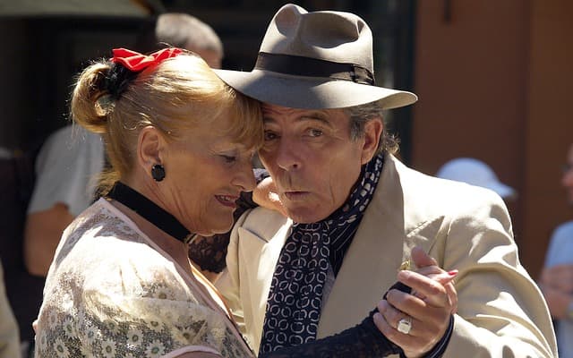 Couples share intimacy through social and recreational activities.